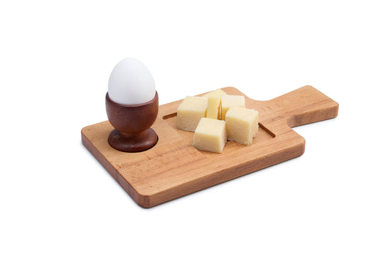 Handy beech wood breakfast board with a handle and two cut-outs for an egg cup, jam or butter. Perfect for serving breakfast, snacks and brunch. Solid oiled beech, easy to clean and gentle on knives. Size: 240 x 130 x 15 mm.