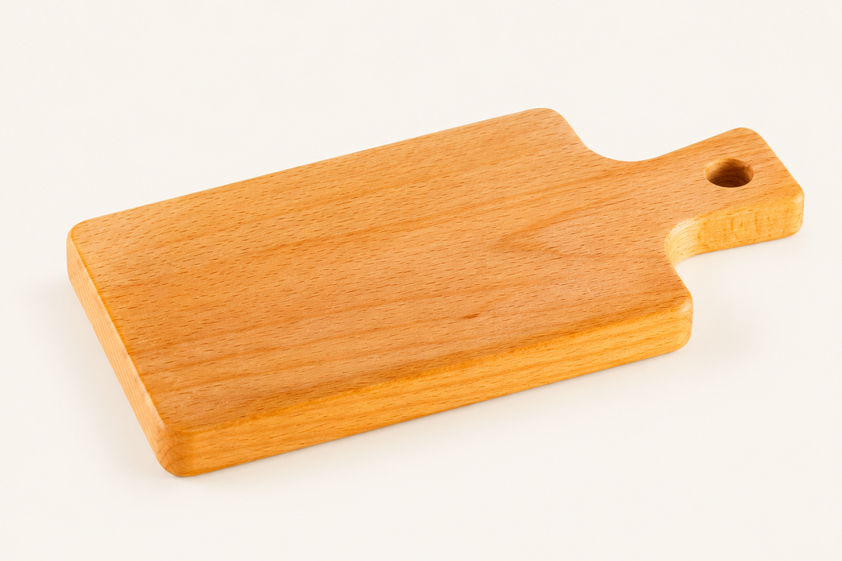 A small rectangular wooden cutting board with rounded corners, a handle, and a hole in the end, shown on a plain light background.